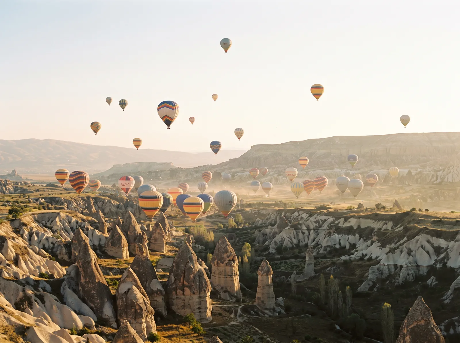 Hot air balloons over Cappadocia's fairy chimneys at sunrise
